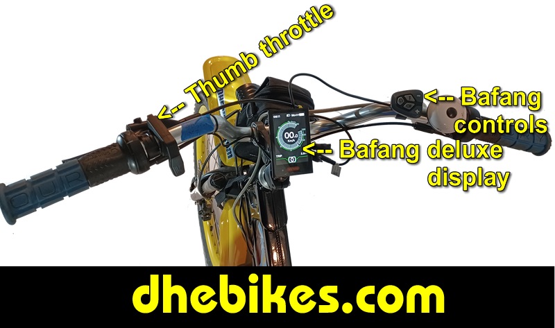 Custom made to order Womens electric downhill mountain bike by Pinnacle Innovations cockpit view showing the GripShift shifters, high rise bar and the Bafang 750 Watt mid mount electric motor throttle.
