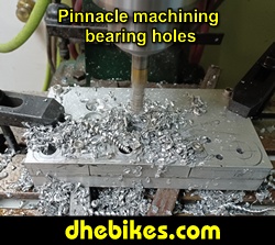 Pinnacle Innovations picture showing machining in progress of the bearing holes for two Norco custom downhill bike's long travel rear suspension linkage plates made from 6061 aircraft aluminum.
