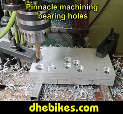 Pinnacle Innovations picture showing machining in progress of the bearing holes for two Norco custom downhill bike's long travel rear suspension linkage plates made from 6061 aircraft aluminum.
