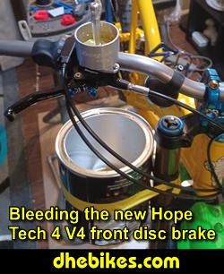 Pinnacle Innovations picture showing bleeding the new Hope Tech 4 Version 4 Downhill Mountain Bike Disc Brakes for a Norco custom electric downhill bike.